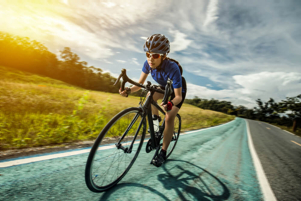 woman cycling with sunglasses